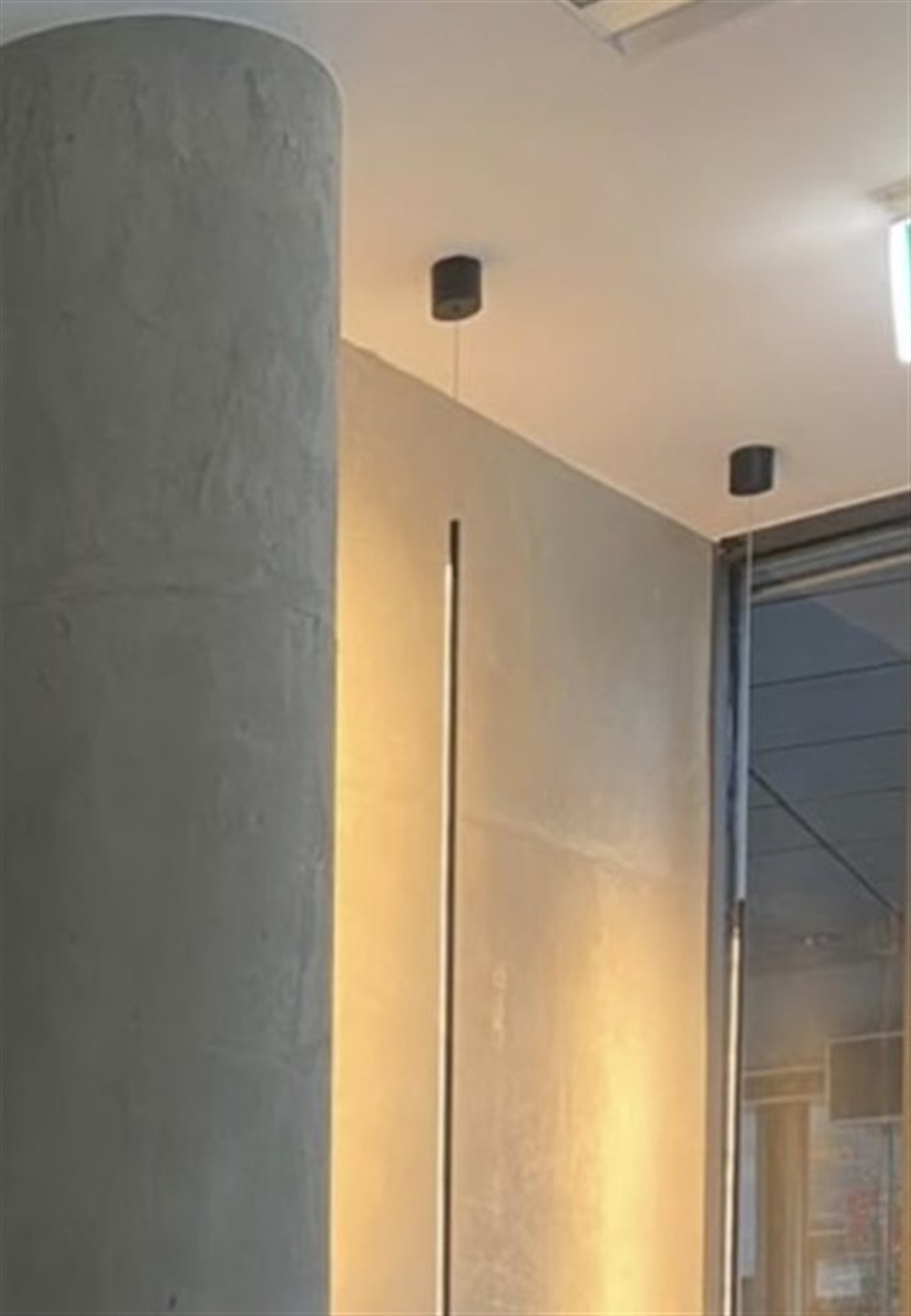Nahaufnahme der Mikrozement-Wand in Betonoptik mit indirekter Lichtkante