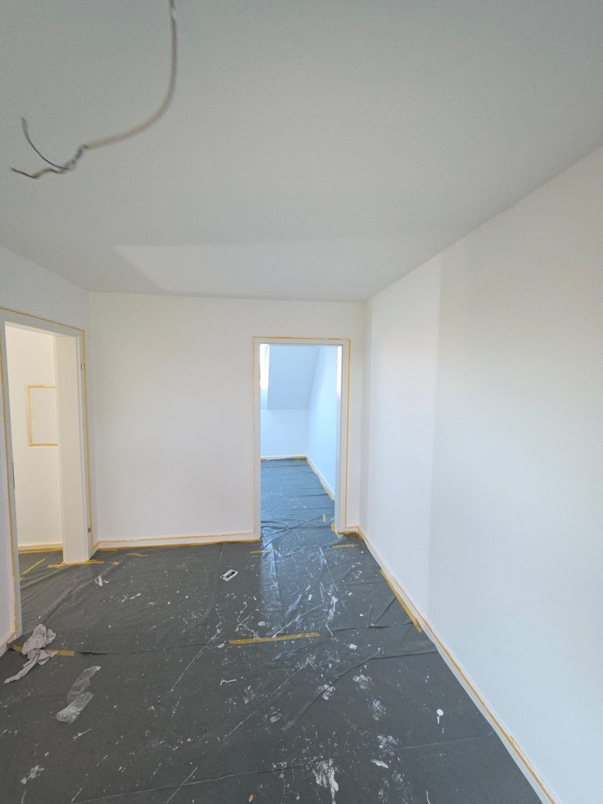 Frisch gestrichenes Zimmer mit Durchblick in die Dachschräge