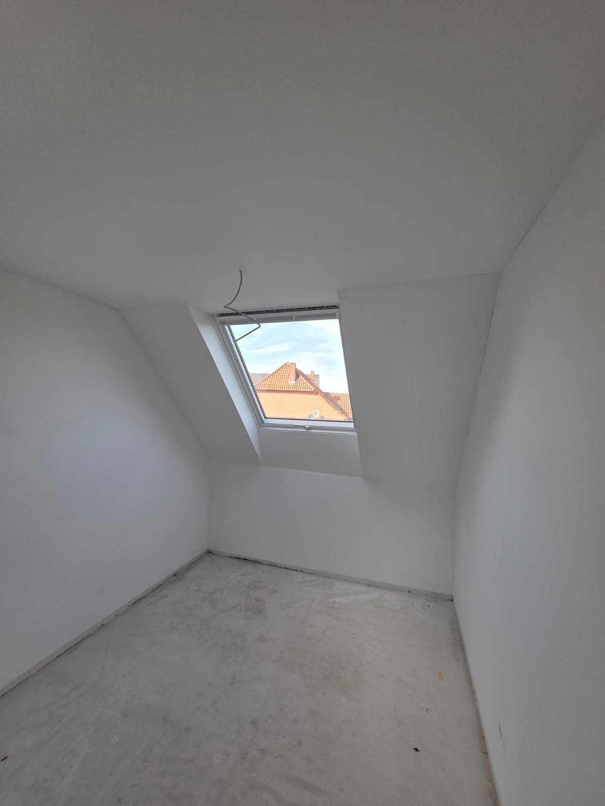 Verspachtelte Dachschräge mit Blick durchs Dachfenster